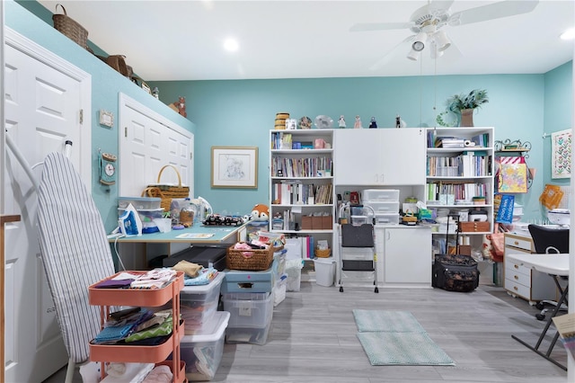 office area with light hardwood / wood-style floors and ceiling fan