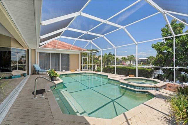 view of swimming pool with a patio area, an in ground hot tub, and glass enclosure