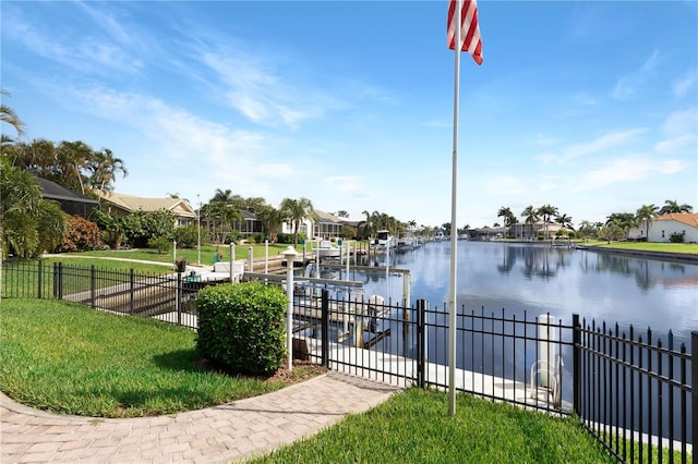 view of dock featuring a water view and a lawn