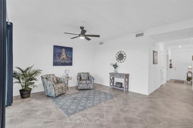 tiled living room with ceiling fan and ornamental molding