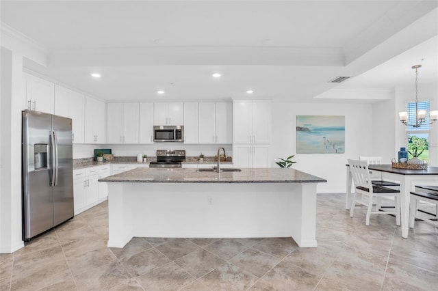 kitchen featuring a kitchen island with sink, white cabinets, stainless steel appliances, sink, and stone countertops