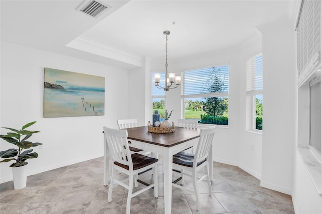 tiled dining area featuring a tray ceiling, a chandelier, and crown molding