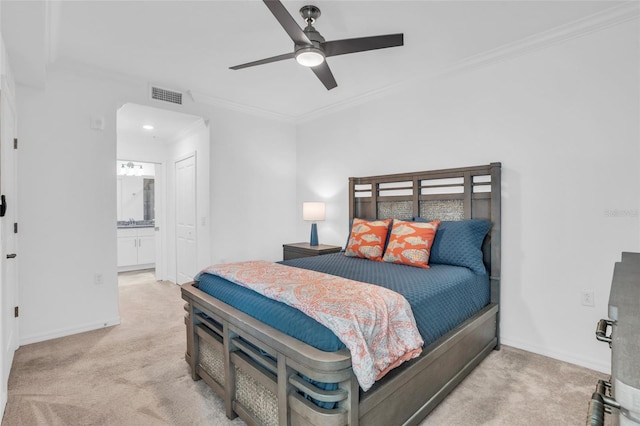 bedroom featuring ensuite bath, ceiling fan, light carpet, and ornamental molding