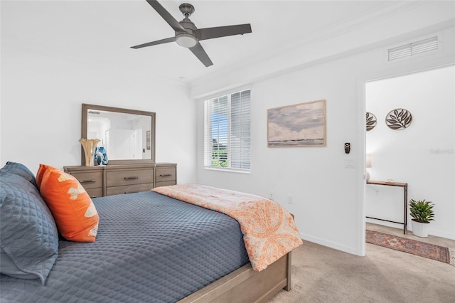 bedroom with crown molding, light colored carpet, and ceiling fan