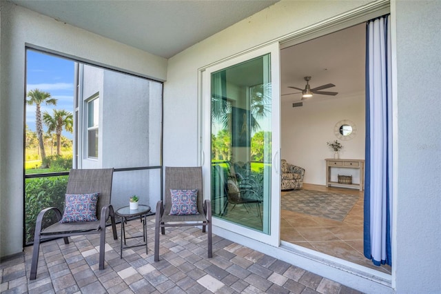 sunroom featuring ceiling fan