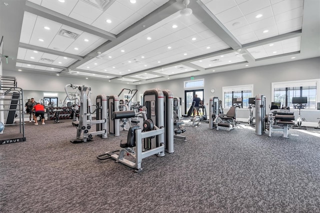 exercise room featuring coffered ceiling and carpet flooring