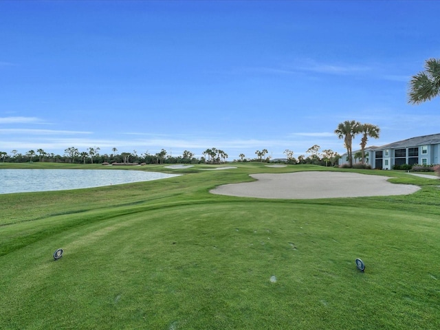 view of home's community featuring a water view and a lawn