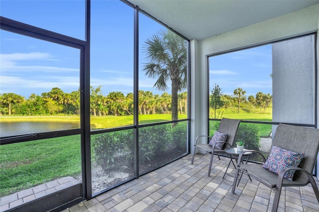 unfurnished sunroom featuring a water view