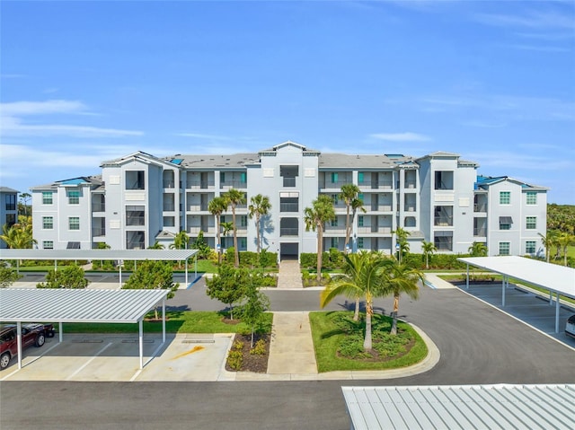 view of property with covered and uncovered parking