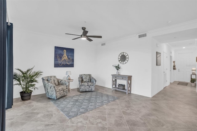 sitting room with ceiling fan, ornamental molding, and visible vents