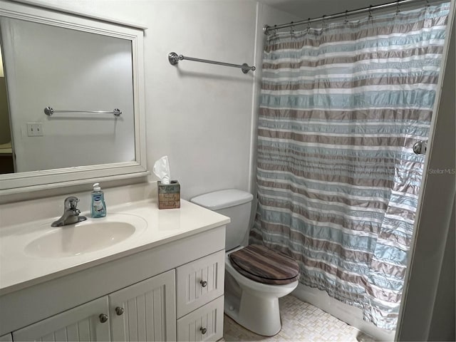 bathroom with vanity, a shower with shower curtain, and toilet