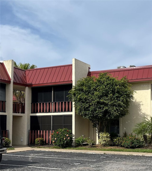 view of building exterior with uncovered parking