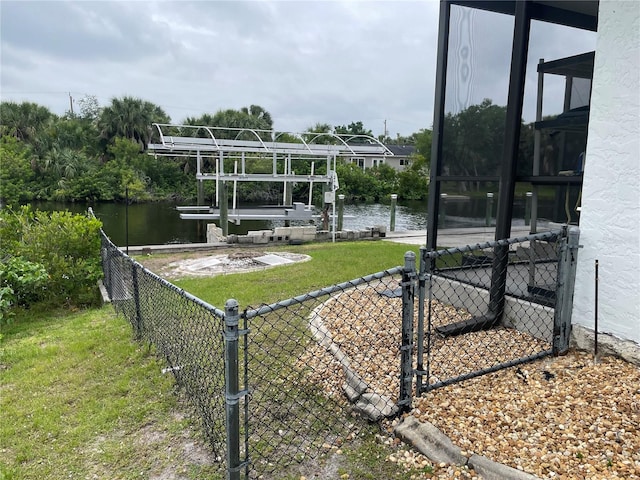 view of yard featuring a water view and a boat dock