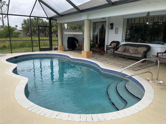 view of swimming pool with a lanai and a patio area