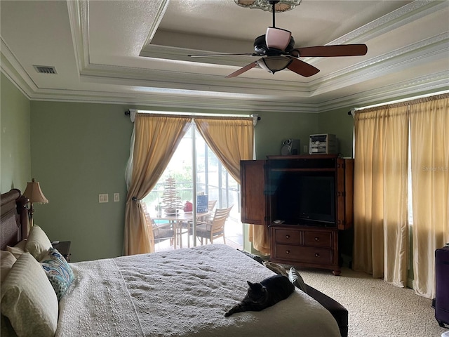 carpeted bedroom with ceiling fan, ornamental molding, a raised ceiling, and access to outside