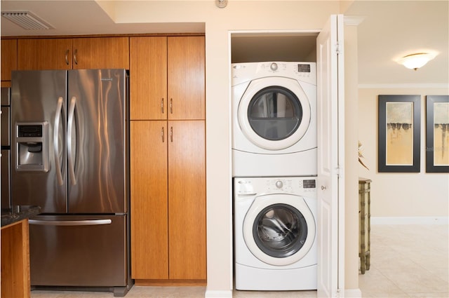 laundry area featuring stacked washing maching and dryer