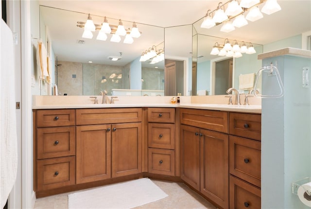 bathroom featuring tiled shower and vanity