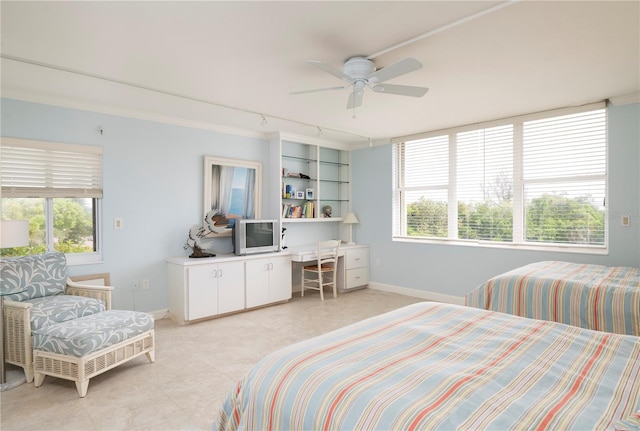 bedroom featuring rail lighting and ceiling fan