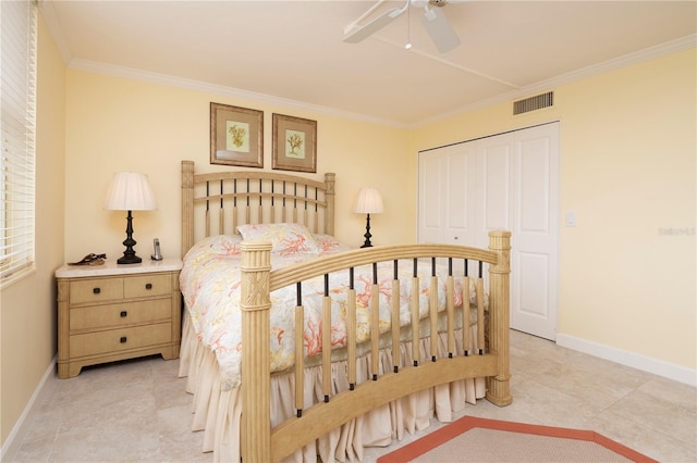 tiled bedroom featuring a closet, ceiling fan, and crown molding