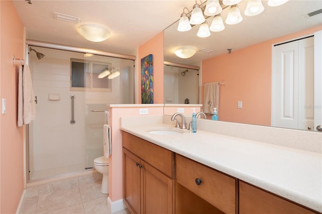 bathroom featuring vanity, toilet, walk in shower, and tile patterned floors