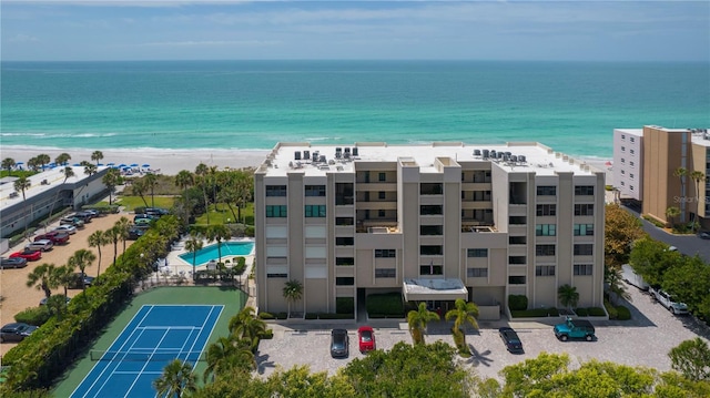 aerial view with a water view and a beach view