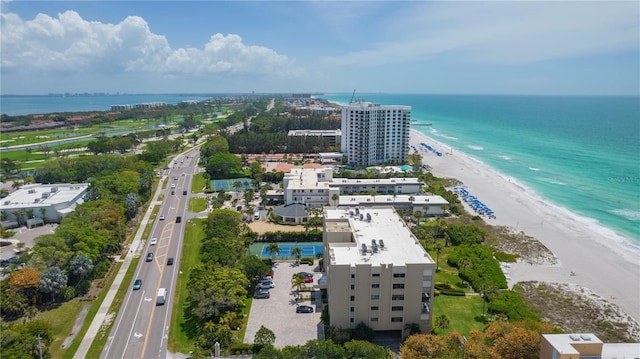 aerial view with a water view and a beach view