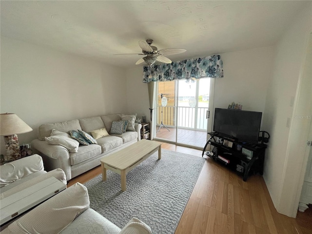 living room featuring light wood-type flooring and ceiling fan