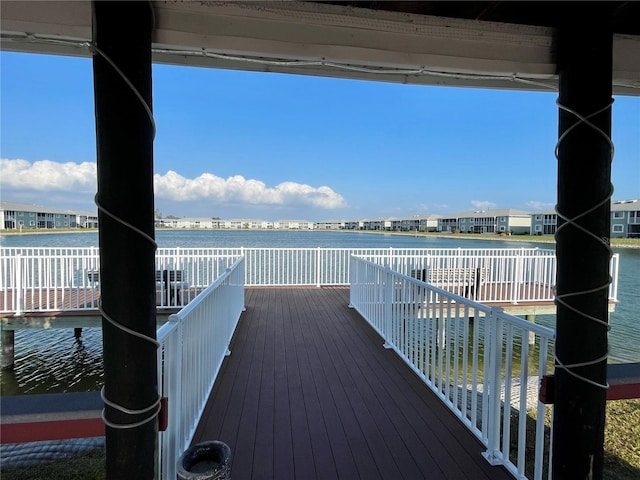 wooden terrace featuring a water view