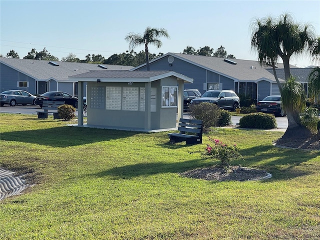 rear view of house with a lawn