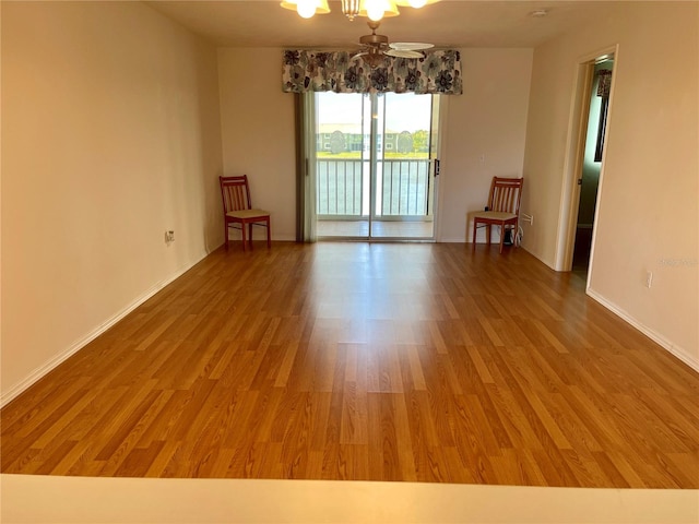 spare room featuring hardwood / wood-style flooring and ceiling fan