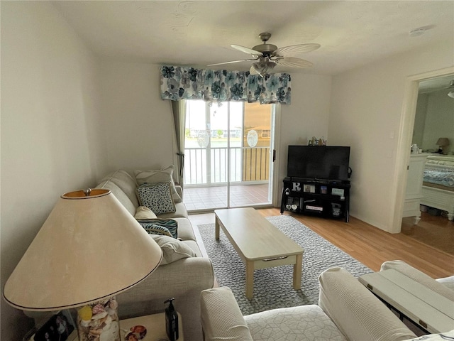 living room featuring ceiling fan and light hardwood / wood-style floors