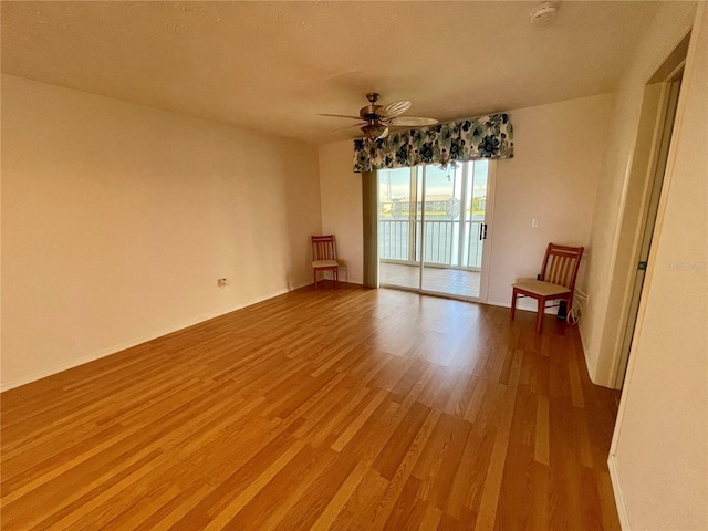 empty room with hardwood / wood-style flooring and ceiling fan