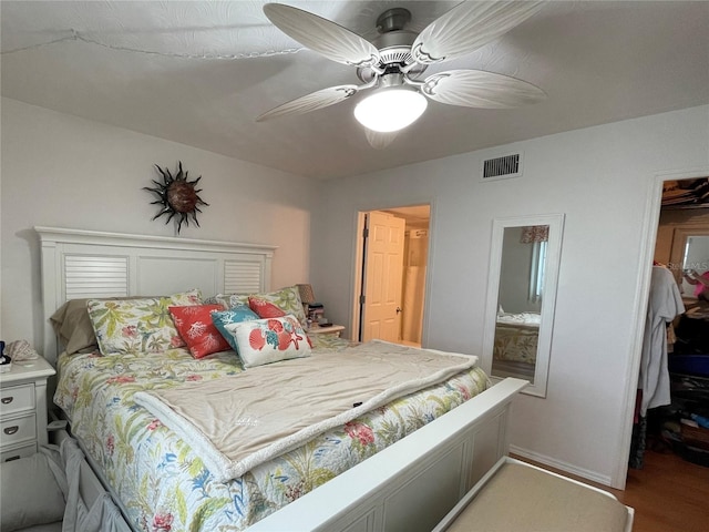bedroom featuring a walk in closet and ceiling fan