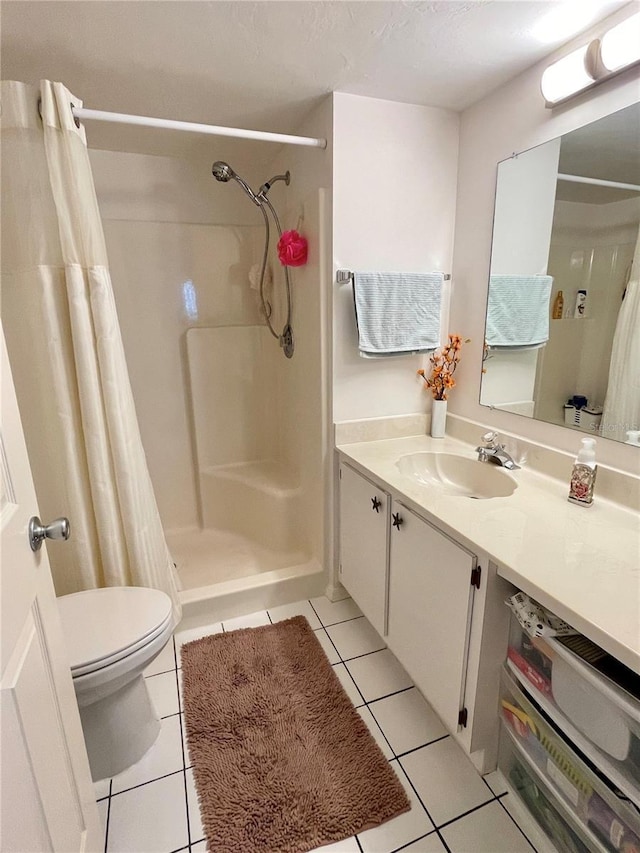 bathroom featuring tile patterned flooring, vanity, a textured ceiling, curtained shower, and toilet
