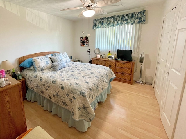 bedroom with light hardwood / wood-style flooring, a closet, and ceiling fan