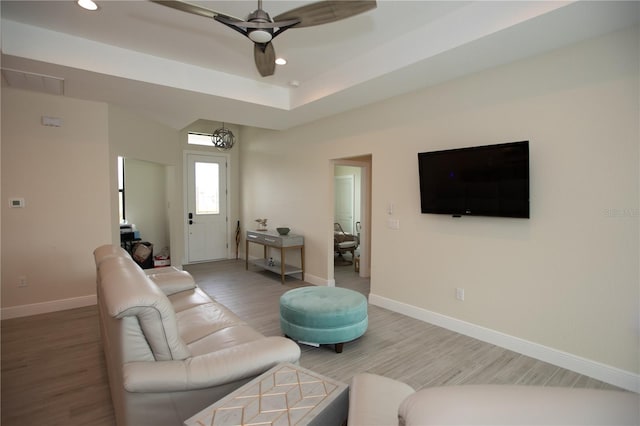 living room with light hardwood / wood-style flooring and ceiling fan