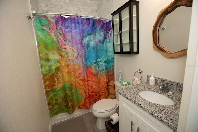 bathroom featuring toilet, tile floors, and large vanity