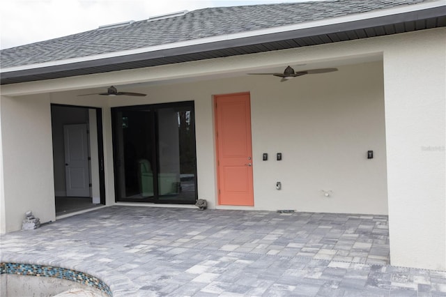 view of exterior entry featuring a patio and ceiling fan