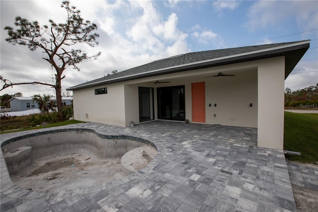 rear view of property featuring a patio and ceiling fan