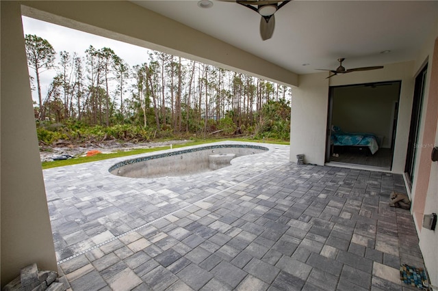 view of pool with ceiling fan and a patio area