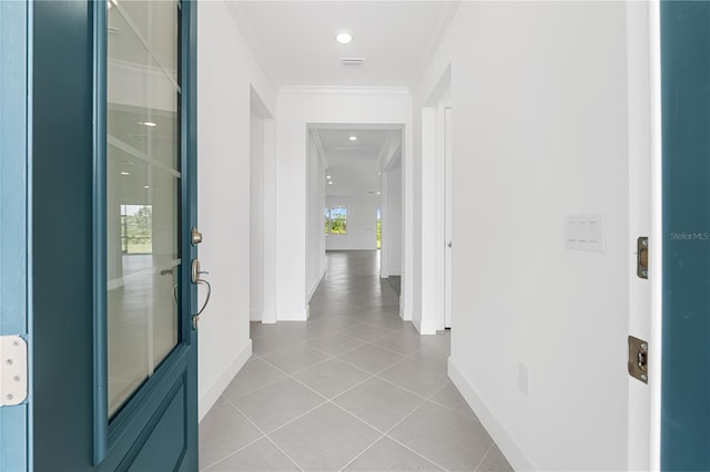 corridor with ornamental molding and light tile patterned floors