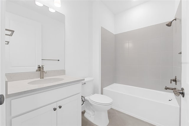 full bathroom featuring toilet, vanity, tile patterned floors, and tiled shower / bath