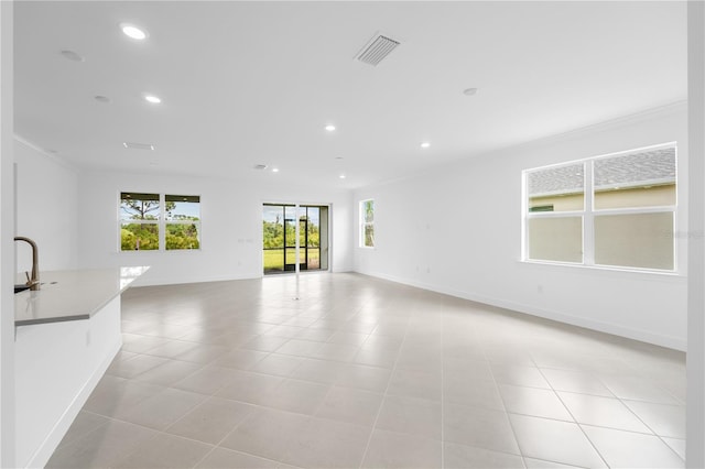 unfurnished room featuring crown molding and sink