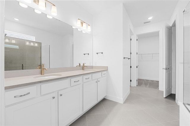 bathroom with vanity, an enclosed shower, and tile patterned floors