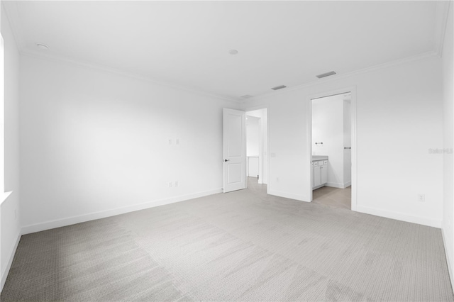 unfurnished bedroom with ensuite bathroom, ornamental molding, and light colored carpet