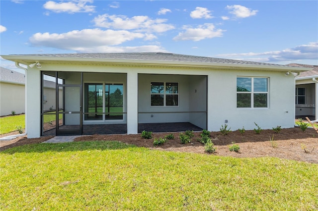 back of house with a yard and a sunroom