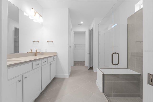 bathroom featuring a shower with door, tile patterned floors, and vanity