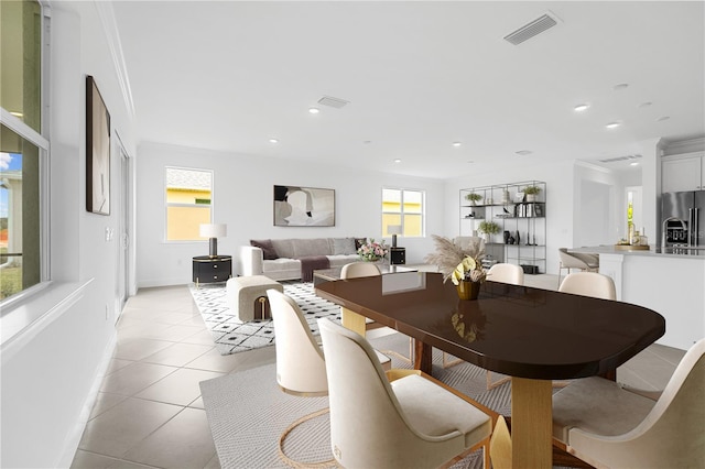 dining room featuring ornamental molding and light tile patterned floors