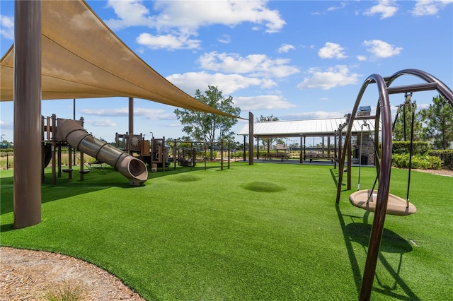 view of community featuring a lawn and a playground