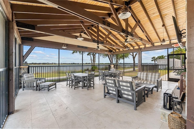 view of patio / terrace with a gazebo, ceiling fan, an outdoor living space, and a water view